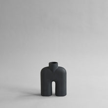 Load image into Gallery viewer, Tall black two-legged ceramic vase for holding flowers
