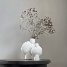 Load image into Gallery viewer, Ceramic asymmetrical textured white large and petite vases with flowers
