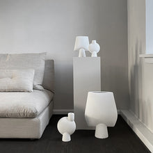 Load image into Gallery viewer, ollection of petite white ceramic vases on display
